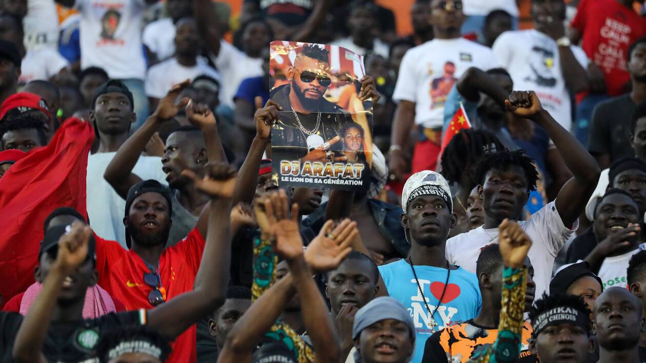 Fans react during a tribute ceremony for DJ Arafat in Abidjan
